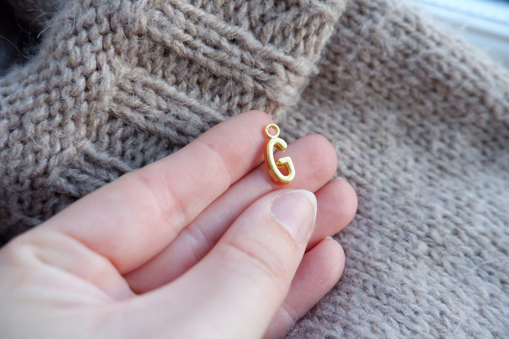 "G"-bogstav-markør (gylden)