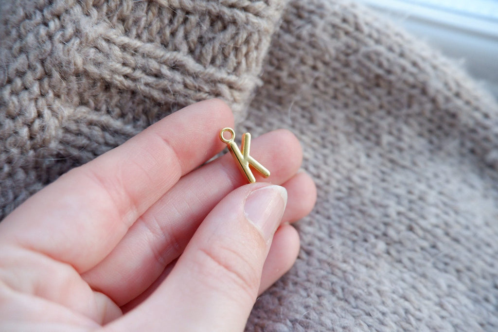 "K"-bogstav-markør (gylden)