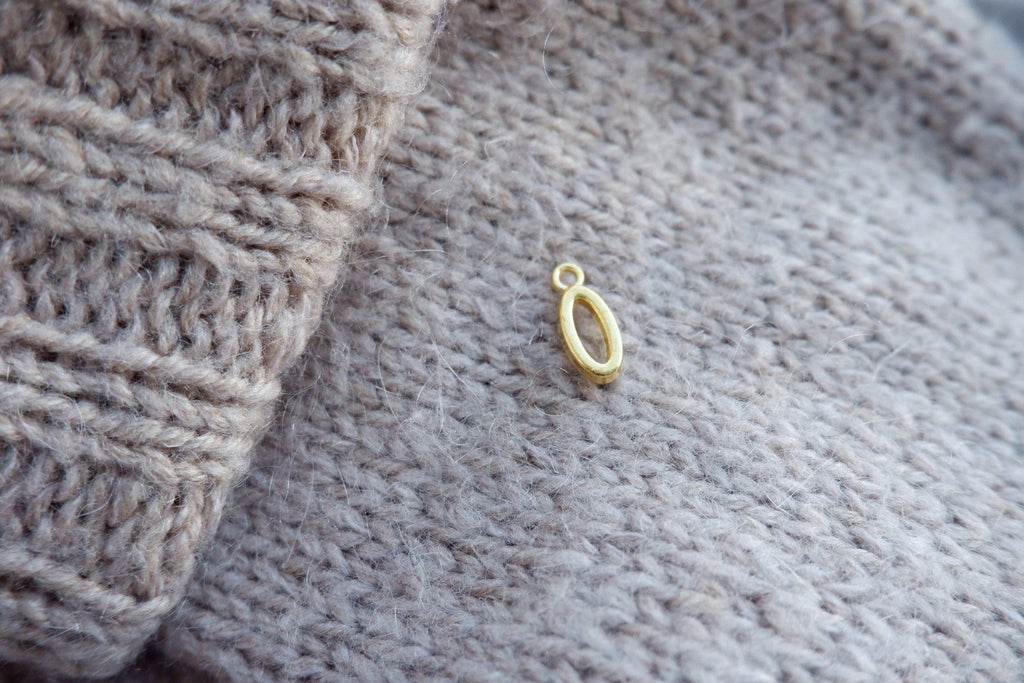 "O"-bogstav-markør (gylden)