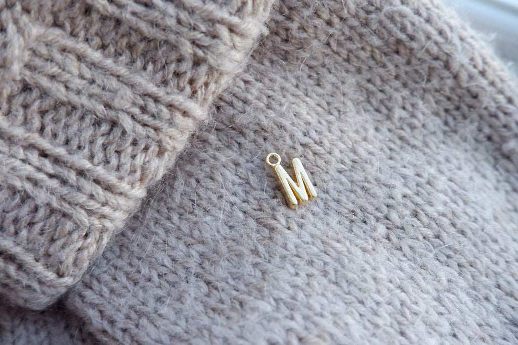 "M"-bogstav-markør (gylden)