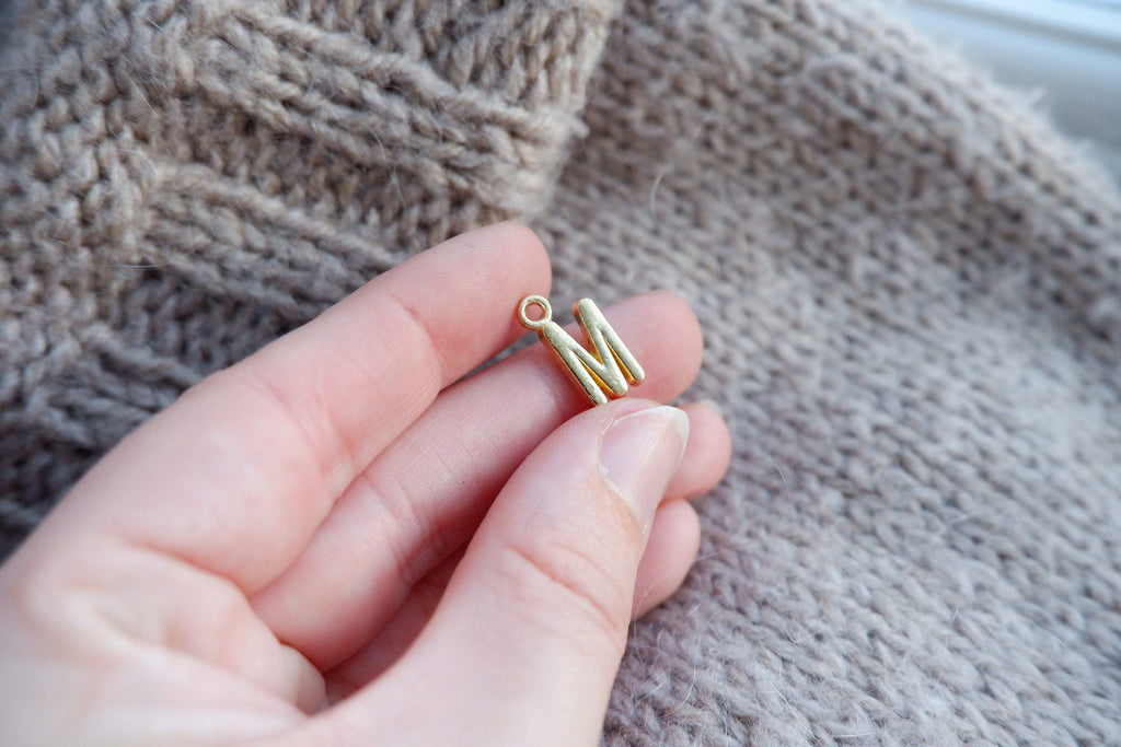 "M"-bogstav-markør (gylden)