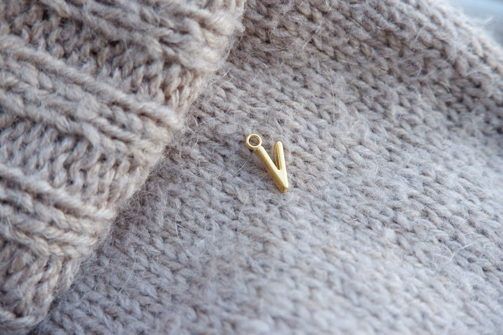 "V"-bogstav-markør (gylden)